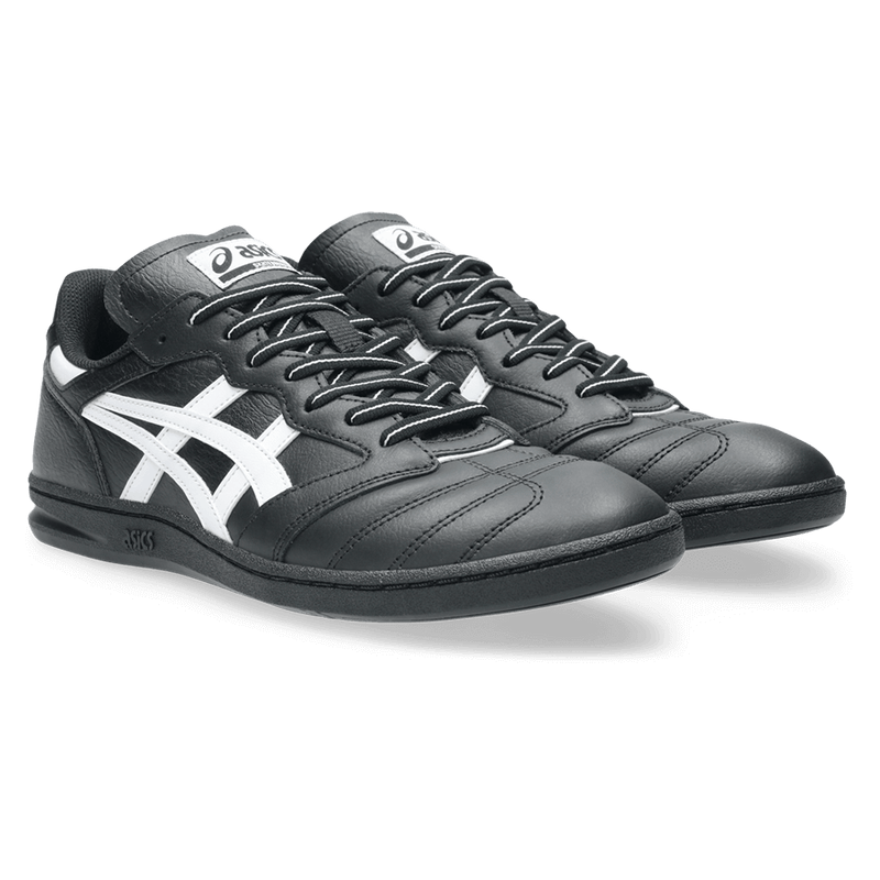 Black and white sneakers with a prominent logo on a transparent background