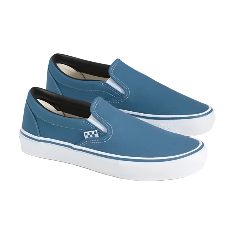 Blue slip-on sneakers with white soles on a light gray background