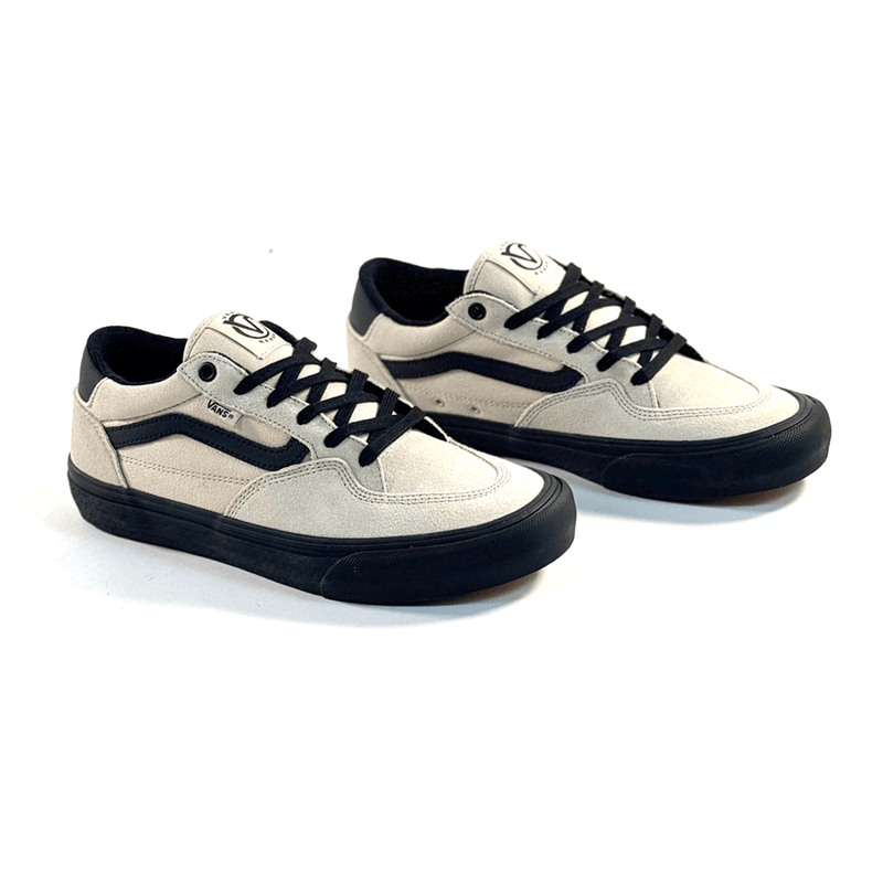 Pair of white sneakers with black accents on a white background